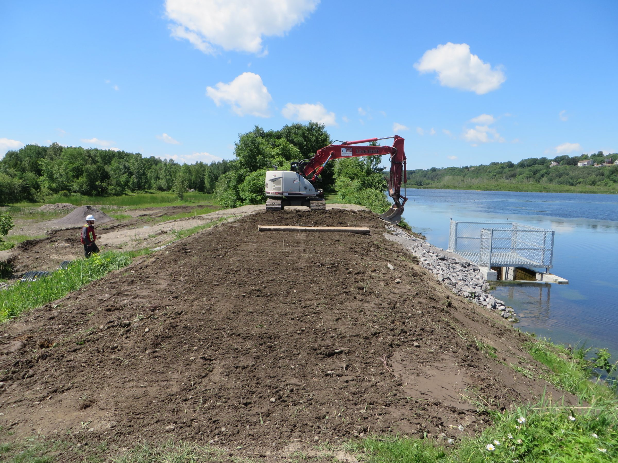 Derniers ajustements à la digue suite au remplacement du barrage à l'exutoire du marais Léon-Provancher. Juillet 2018. Photo : Réhaume Courtois.
